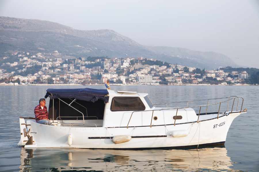 Ljubo fishing on his boat